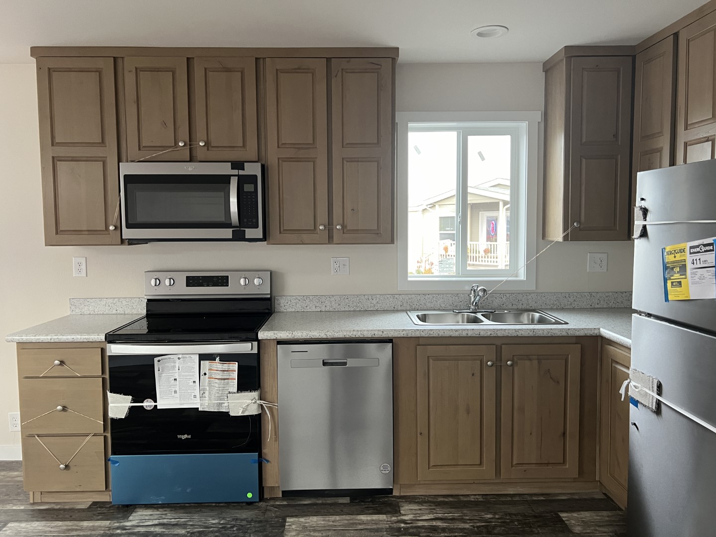 Space-efficient kitchen with stainless steel appliances in the Legacy singlewide.